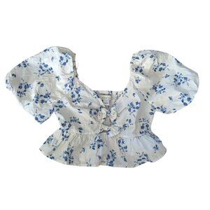 Blue floral print puff sleeve bows crop top by the brand Band of the Free